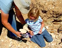 Instructor showing Summer some fossile samples